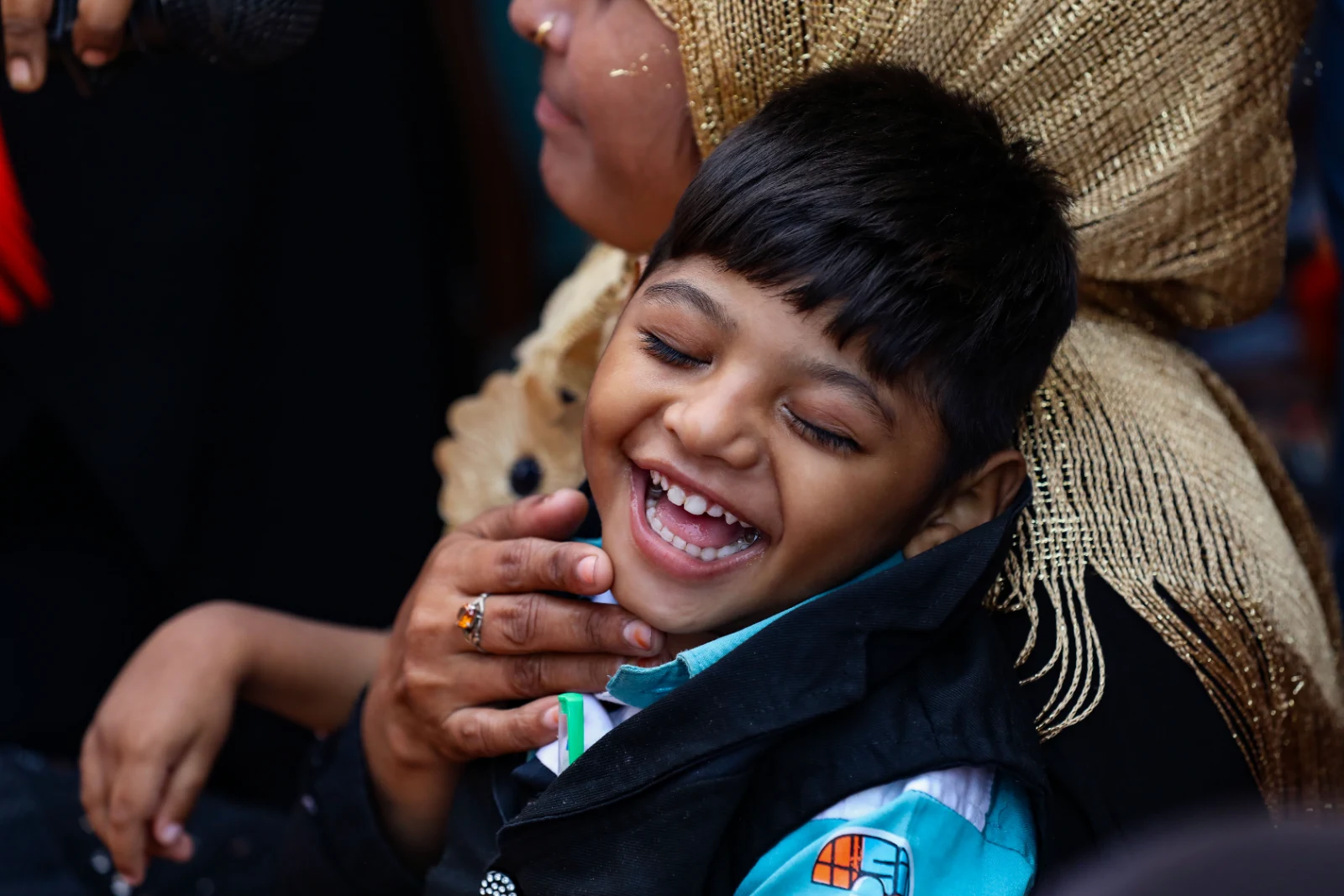 Child smiling during a sports and recreational activity at Garden Reach Institute